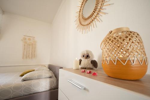 - une chambre pour enfants avec un lit et un panier en osier dans l'établissement La Chouette de la Cathédrale - Calme - Jardin - Wifi, à Troyes