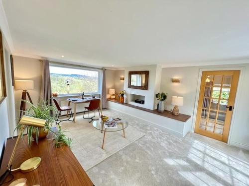 a large living room with a table and chairs at Treetops Cottage at Treetops Hideouts in Richmond