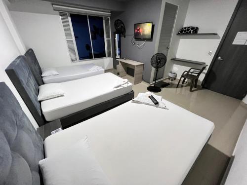 a room with two beds and a table at la cascada1624 in Lemos