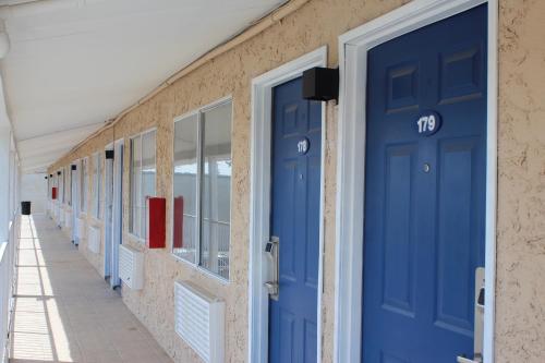 a row of blue doors on the side of a building at Travelodge by Wyndham Blythe in Blythe