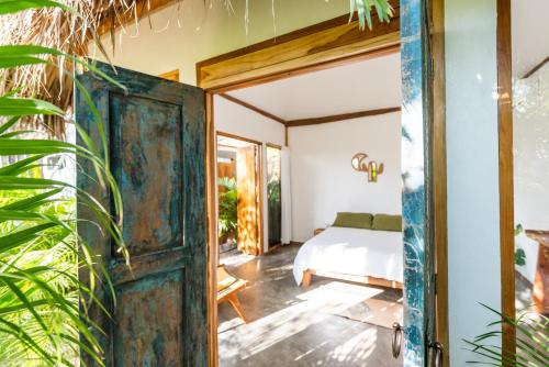an open door leading to a bedroom with a bed at Lucero in Santa Teresa Beach