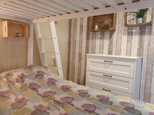 a bedroom with a bed and a white dresser at FeWo Westwind in Fehmarn