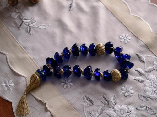 a blue glass bead bracelet on a table at Νatasas Place in Evia in Amarinthos