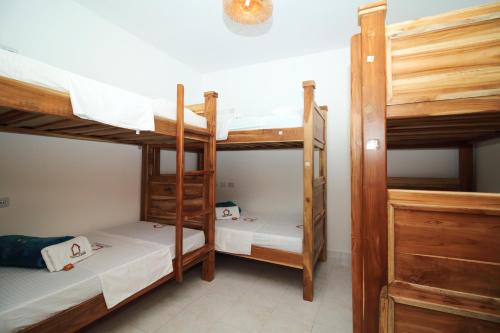 a room with three bunk beds in a hostel at Hostal Casa Torres Centro Historico - Adults Only in Cartagena de Indias