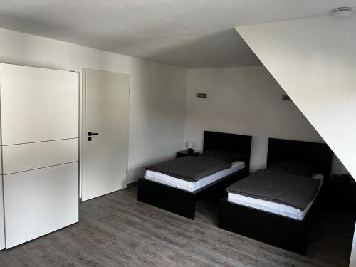 a bedroom with two beds and a closet at Ferienwohnung am See No.1 in Borken