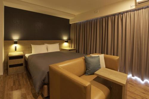 a hotel room with a bed and a couch at Sakura Terrace The Gallery in Kyoto