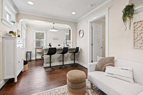 a living room with a white couch and a kitchen at Historic Heights Cozy Nook Apartment in Houston