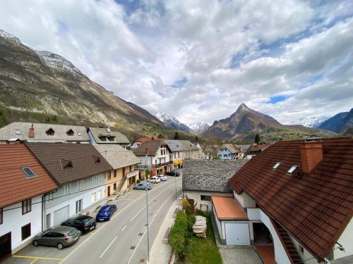 a town in the mountains with cars parked on the street at Cozy Apartment Bovec in Bovec