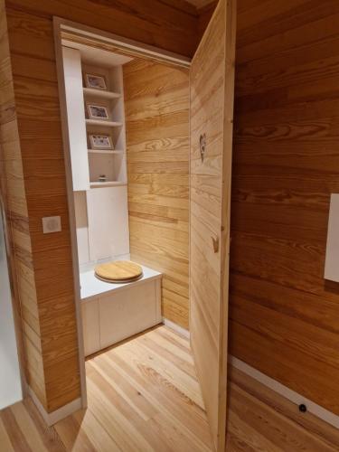 a sauna with wooden walls and wooden flooring at L'écolodge de Laeti in Lunéville