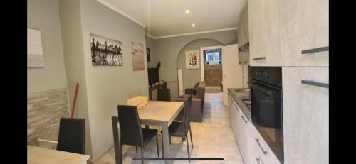 cocina y comedor con mesa y sillas en Crystal Home, en La Spezia