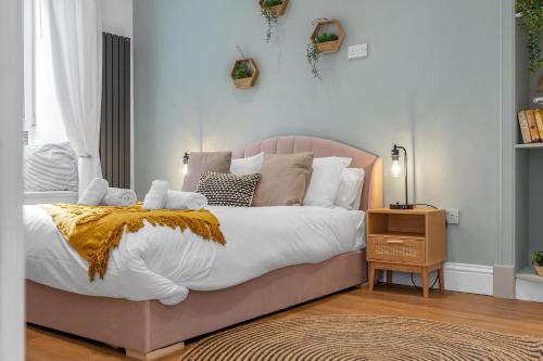 a bedroom with a large bed with a yellow blanket at Jamson Pl Apartment in Edinburgh