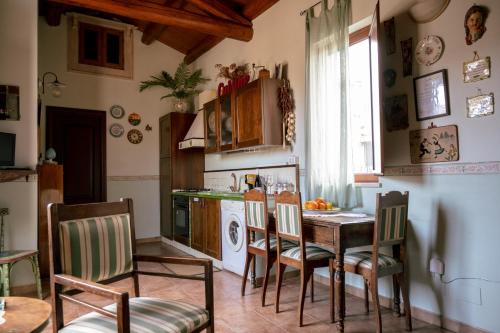 a kitchen with a table and chairs in a room at Tetti & Chiese - Authentic Sicilian Rooftop in Catania