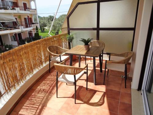 a patio with a table and chairs on a balcony at Lefkada CP Residences in Lefkada Town