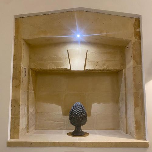 a sculpture in a box with a light on it at Dadaumpa suite in Lecce
