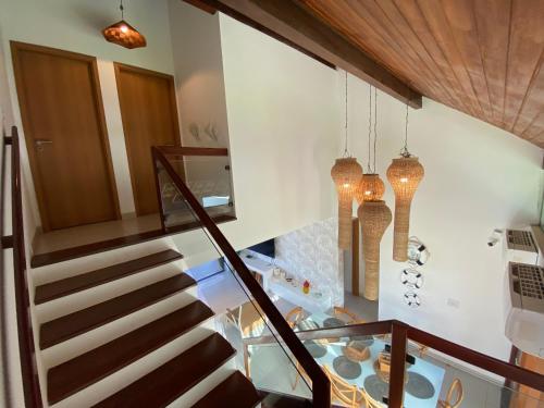 a staircase in a house with chandeliers at Bangalô Porto Galinhas in Porto De Galinhas