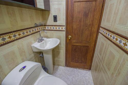 a bathroom with a toilet and a sink at Espectacular casa cerca a parques turisticos in Medellín