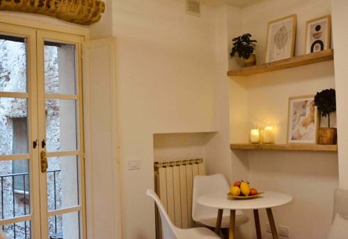 a small table and chairs in a room with a window at Una perla in pieno centro in Perugia
