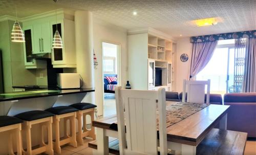 a kitchen and dining room with a table and chairs at Santorini Unit RR in Margate