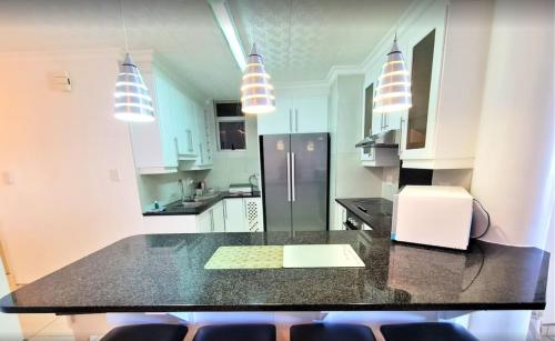 a kitchen with a black counter top in a room at Santorini Unit RR in Margate