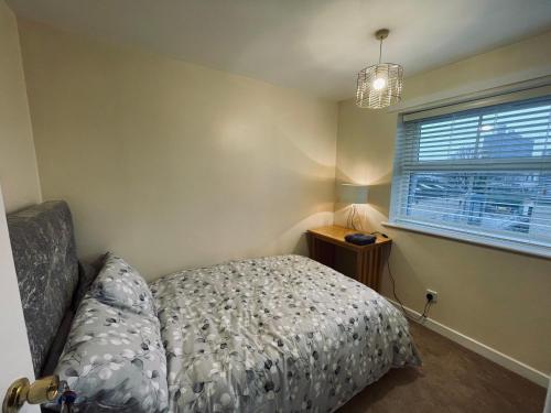 a small bedroom with a bed and a window at Two Double bedrooms apartment near Hull city centre in Hull