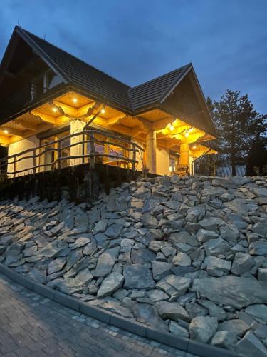 a large building with a large stone floor at Gliniana Chata in Zawoja