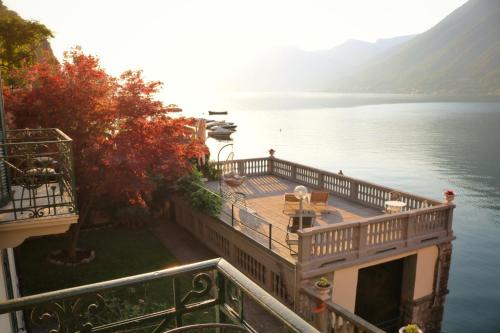 a balcony with a view of a body of water at Ortensie & Oleandri al Lago - by MyHomeInComo in Argegno