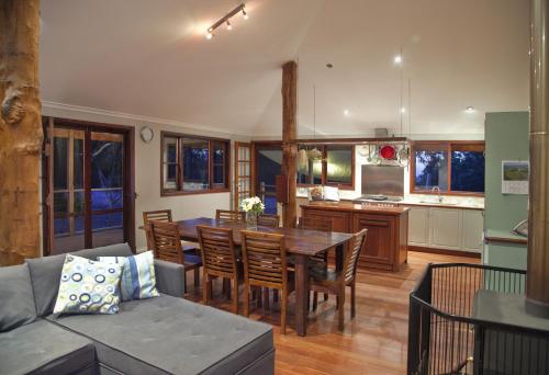 a living room with a wooden table and chairs at Wildwood Valley in Yallingup