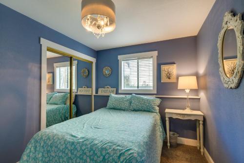 a blue bedroom with a bed and a mirror at Coastal Tillamook Vacation Rental Ocean Views! in Tillamook