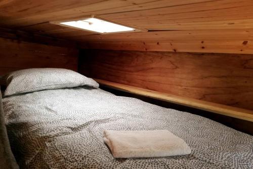 a bedroom with a bed in a wooden cabin at Truck & Pod creative nature retreat. in Bantry