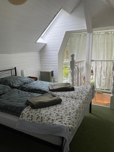 two beds sitting in a room with a window at Ferienhaus Weniger in Bad Saarow