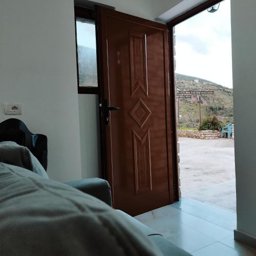 a wooden door with a view of a room at FarmHouse Qeparo in Qeparo