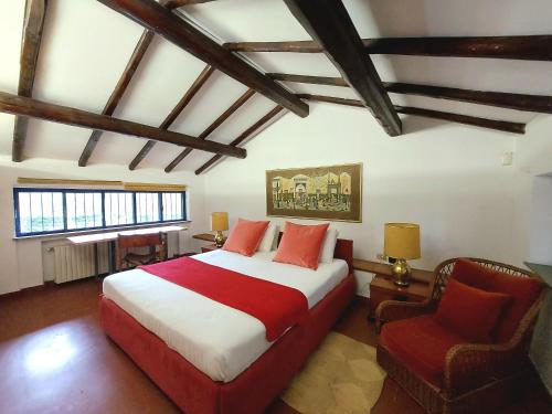 a bedroom with a large bed and a chair at Villa with private pool and garden in Tradate