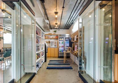 a room with glass doors and a hallway with rugs at Trumbull and Porter - Detroit Downtown in Detroit