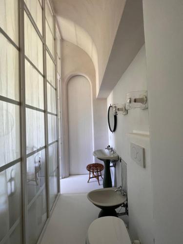 a bathroom with a toilet and a window at Villa Eletta, Capri in Capri