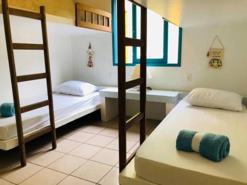 Postel nebo postele na pokoji v ubytování Morada Bromélias praia da Ferrugem