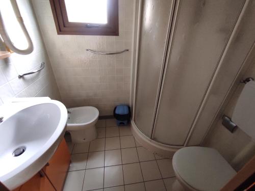 a bathroom with a shower and a toilet and a sink at L'Oasi di Lulu' in Senigallia