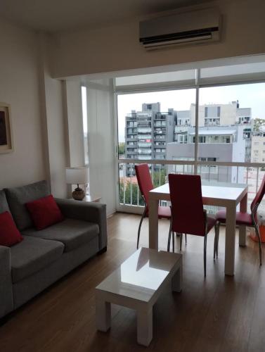 a living room with a couch and a table at Departamento Zona Puerto De Olivos in Olivos