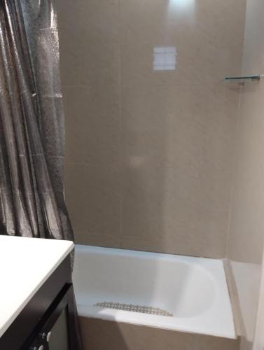 a shower in a bathroom with a shower curtain at Departamento Zona Puerto De Olivos in Olivos