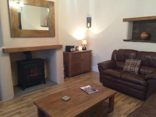 a living room with a couch and a fireplace at Masonic House, Alston in Alston