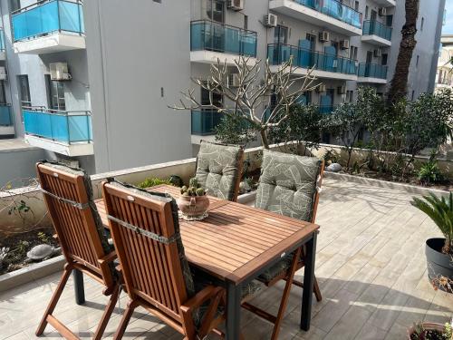 a wooden table and chairs on a patio at Psaropoula's Hidden Gem in Rhodes Town