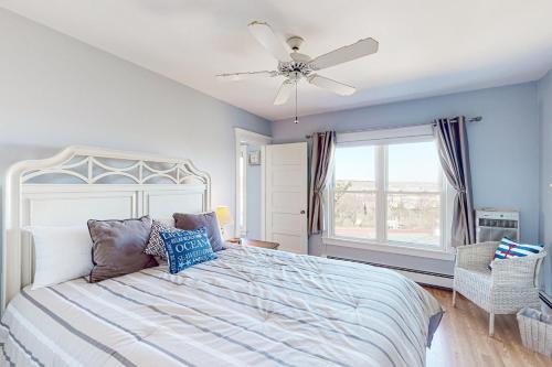 a bedroom with a bed and a ceiling fan at The Lookout #210 in Ogunquit