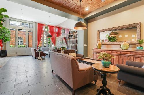 a lobby with chairs and a mirror and a table at Roami at Factors Row in New Orleans