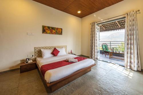 a bedroom with a large bed and a large window at Tranquil Mulshi Villa with 4 Bedrooms in Mulshi