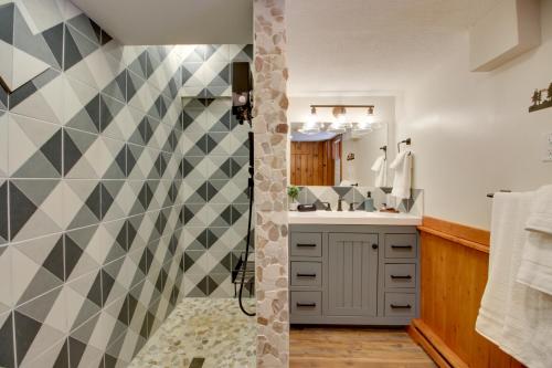 a bathroom with a checkered wall at Away at Moose Bay Breezy Point Gem with Game Room in Breezy Point