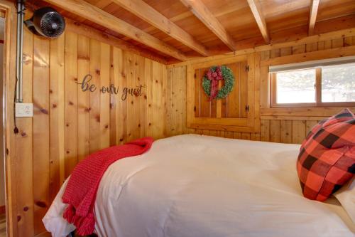 a bedroom with a bed in a wooden cabin at Away at Moose Bay Breezy Point Gem with Game Room in Breezy Point