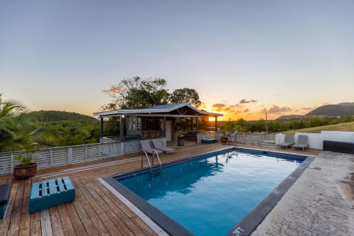 a swimming pool on a deck with a gazebo at South Coast Horizon in Curtain Bluff