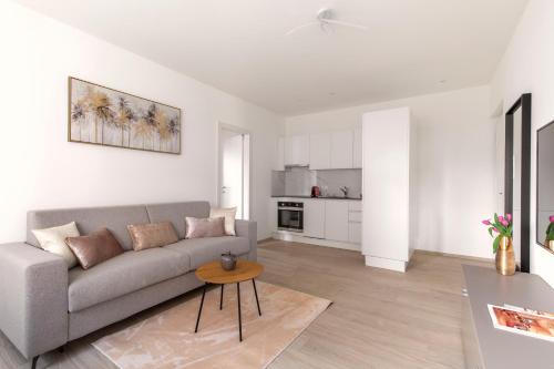 a living room with a couch and a table at Lugano Superior Suites - Free Parking in Lugano