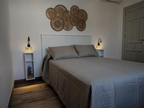 a bedroom with a bed and two lights on the wall at Villa Delicia in Torrox
