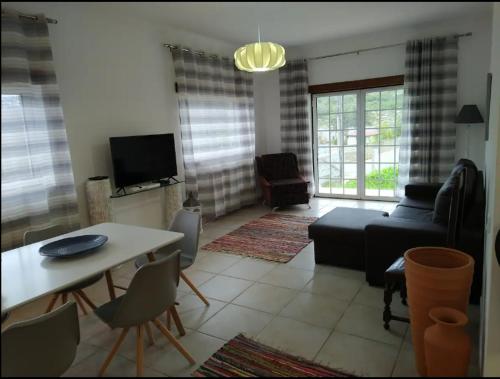 a living room with a couch and a table at Casa do Espinheiro in São Mamede