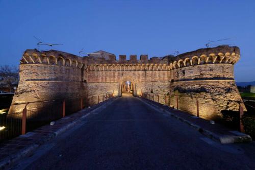 an entrance to a large castle with a roadway at Villa Luisa Design in Colle Val D'Elsa